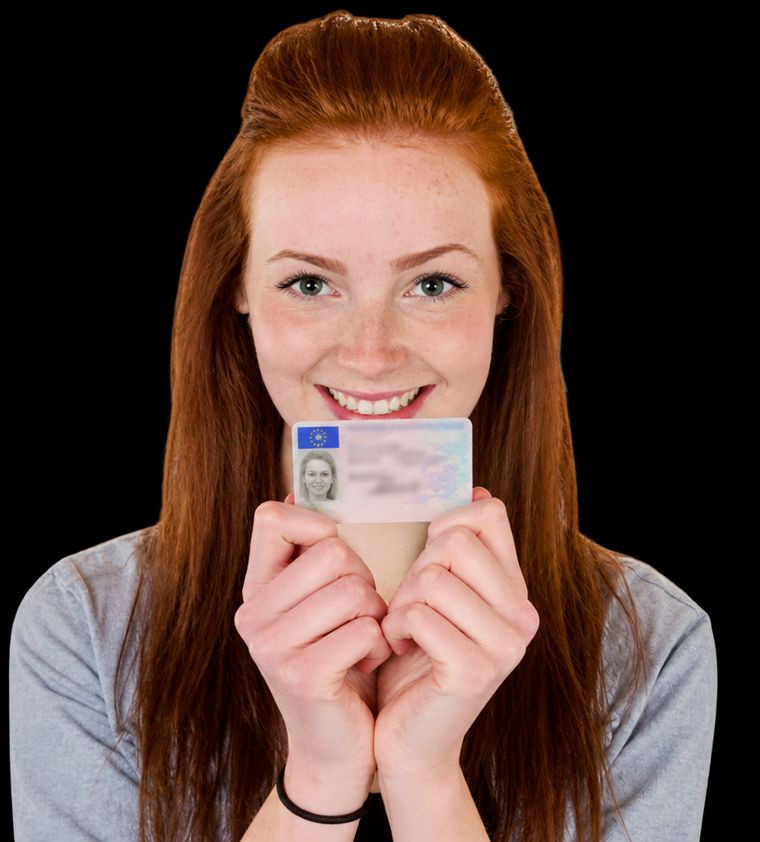 Smiling learner holding up her new driving licence