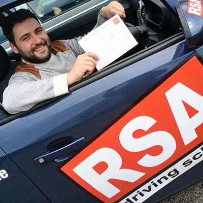 Learner with his pass certificate in an RSA School of Motoring car